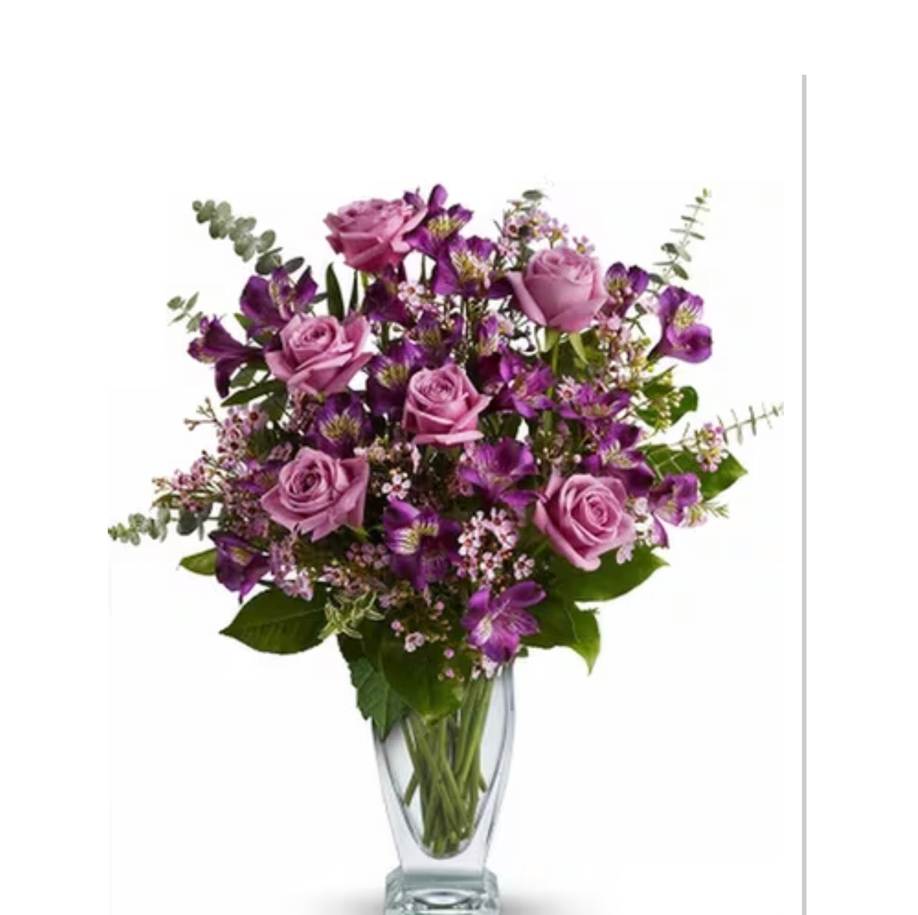 Lavender roses and purple alstroemeria with eucalyptus in crystal vase