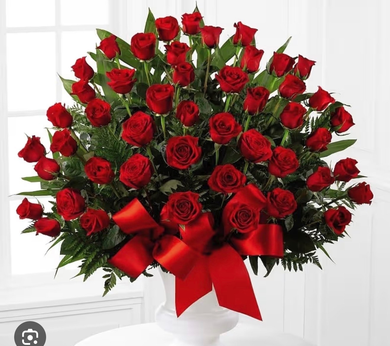 Red rose urn arrangement with red satin bow