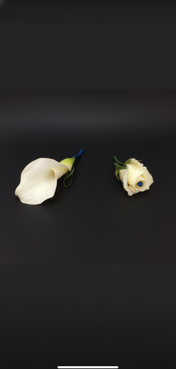 White calla lily and cream rose boutonnieres with blue ribbon