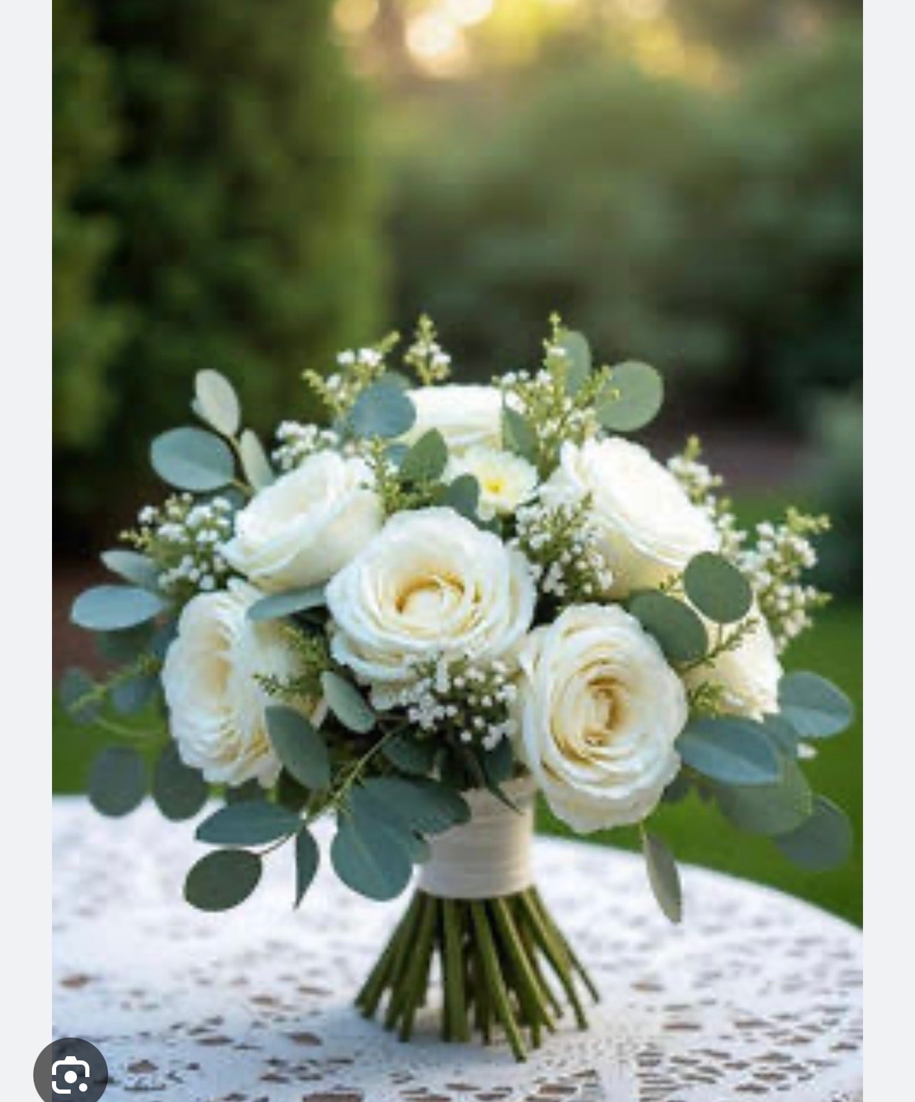 White rose and eucalyptus bridal bouquet on table